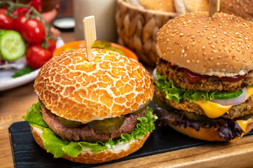 Tasty vegetarian cheeseburgers and hamburgers with round patties or burgers made from grains, vegetables and legumes