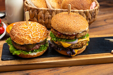 Tasty vegetarian cheeseburgers and hamburgers with round patties or burgers made from grains, vegetables and legumes