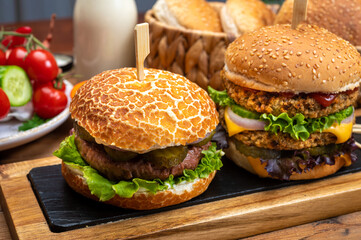 Tasty vegetarian cheeseburgers and hamburgers with round patties or burgers made from grains, vegetables and legumes