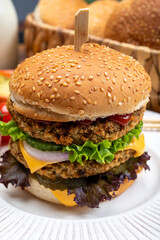 Tasty vegetarian cheeseburgers with round patties or burgers made from grains, vegetables and legumes