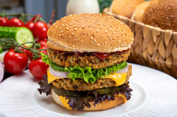 Tasty vegetarian cheeseburgers with round patties or burgers made from grains, vegetables and legumes