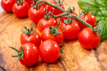 Ripe small round sweet red cherry tomatoes close up