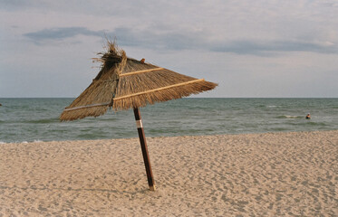 Umbrella on a sandy beach against the sea.
