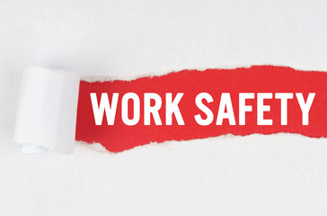 Behind torn white paper on a red background, the text - WORK SAFETY