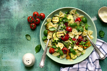 Pasta primavera - traditional italian dish. Top view with copy space.