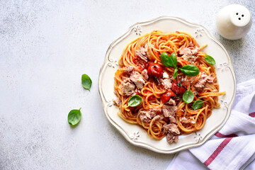 Spaghetti pasta with tuna in tomato sauce. Top view with copy space.