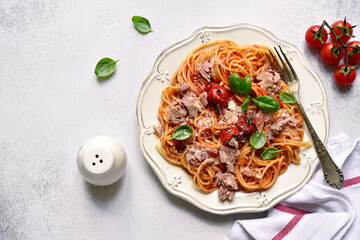 Spaghetti pasta with tuna in tomato sauce. Top view with copy space.
