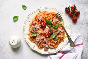 Spaghetti pasta with tuna in tomato sauce. Top view with copy space.
