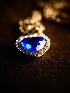 Vertical Shot Of A Luxury Necklace From Gold With Blue Gemstones