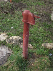 iron hydrant of red color for water intake from a well