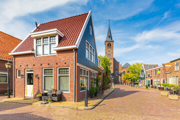 Old streets in Volendam, old traditional fishing village, typical wooden houses architecture
