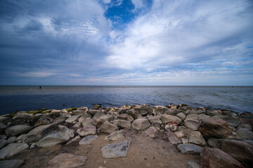 Fototapeta na wymiar empty sandy beach by the sea with rocks