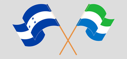 Crossed and waving flags of Honduras and Sierra Leone