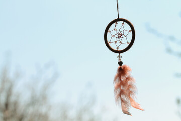Dreamcatcher with crystal beads on the sky background. Mascot.