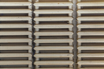 Old painted heating radiator. Pink dirty color. View from the front