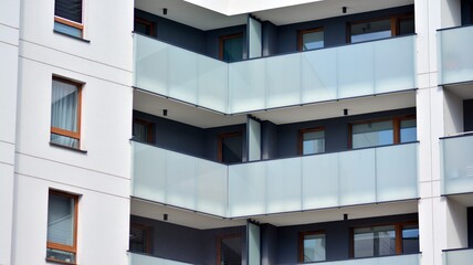 Architectural details of modern apartment building. Modern european residential apartment building complex with sunlight.