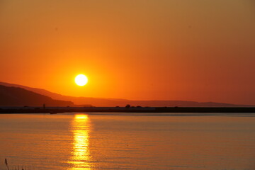 Sunset over the hills and the sea