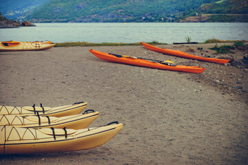 Kayaks on fjord shore, Flam, Norway