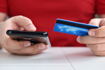 Man's hands holding credit card