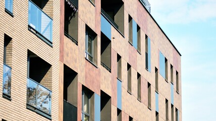 Architectural details of modern apartment building. Modern european residential apartment building complex with sunlight.