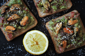Open sandwiches with guacamole and mussels. Healthly food. The keto diet.