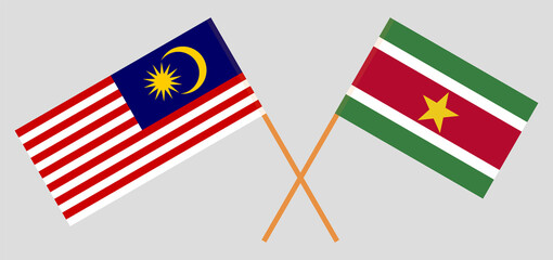 Crossed flags of Malaysia and Suriname. Official colors. Correct proportion