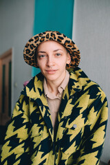 Woman with short hair wearing stylish panama looking at the camera while posing