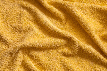 detail of a yellow soft plush towel for personal hygiene with ripples forming a nice texture