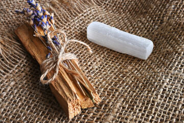 A top view image of Palo Santo with dried lavender on a burlap background. 