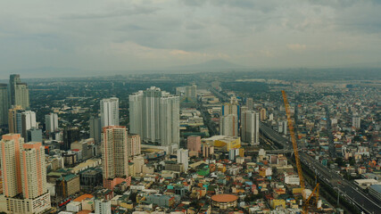 Manila city with skyscrapers, modern buildings and Makati business center, aerial drone. Travel vacation concept.