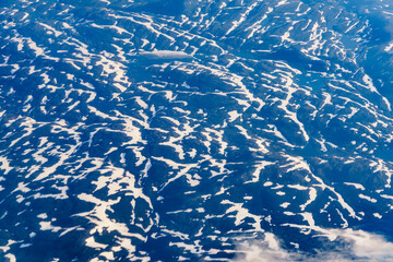 View from airplane to clouds and land