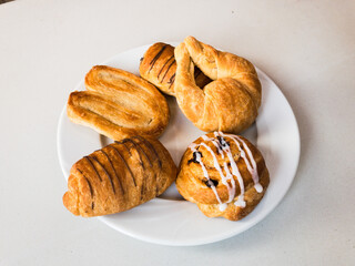 Bread with chocolate and glaze on a white plate
