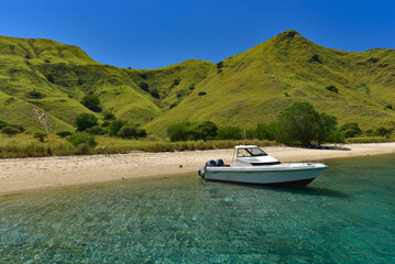 A boat resting on the shore of an island in Indonesia