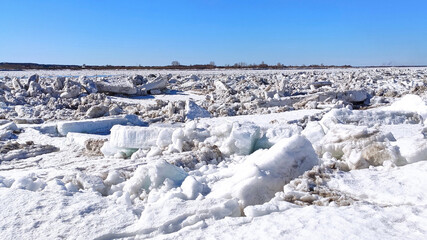 Large white pieces of cracked ice. Spring ice melting and ice drift on the river. Global warming. High quality photo