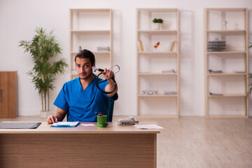 Young male doctor cardiologist working in the clinic