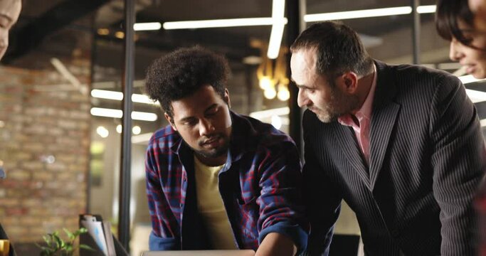 College students discussing project with professor. Young creative developers or designers talking to team leader while brainstorming - creativity, teamwork, education 4k footage