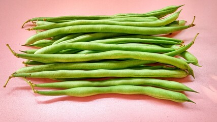 Fresh green bean pods, a type of edible legume, are a healthy green food rich in protein