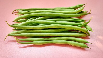 Fresh green bean pods, a type of edible legume, are a healthy green food rich in protein