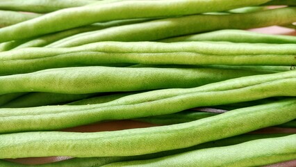 Fresh green bean pods, a type of edible legume, are a healthy green food rich in protein