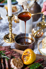 Sliced steak on a board with bordelaise sauce