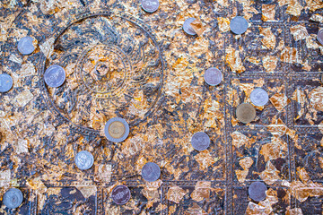 The tradition of throwing coins and sticking gold foil on sacred objects to bring luck in Thailand,A pieces of gold foil texture stick together. Golden background and texture.