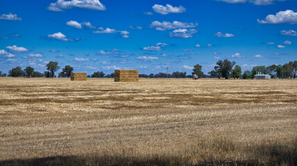 Large Haystacks Behind Farm House