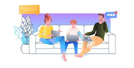 family using laptops parents wih child relaxing on sofa social media online communication concept