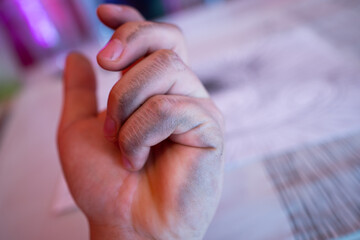 man shows the problem lefties dirty hand after writing close-up international left handers day.