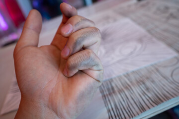 man shows the problem lefties dirty hand after writing close-up international left handers day.