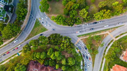 Aerial Drone view of residential traffic street road with moving cars
