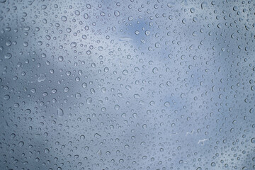 Water drops on glass of car sunroof with copy space,Rain drops on SUV glass panoramic sunroof. Abstract irregular water drops background with seamless pattern.