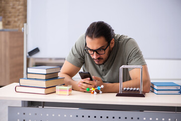 Young male student preparing for exams in the classroom