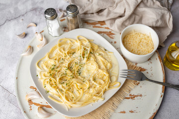 Alfredo pasta dinner with creamy white sauce with herbs seasoning. Pasta made in Italian restaurant called Alfredo. Cheese Alfredo Pasta.