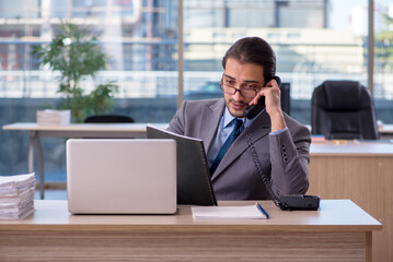 Young male employee working in the office